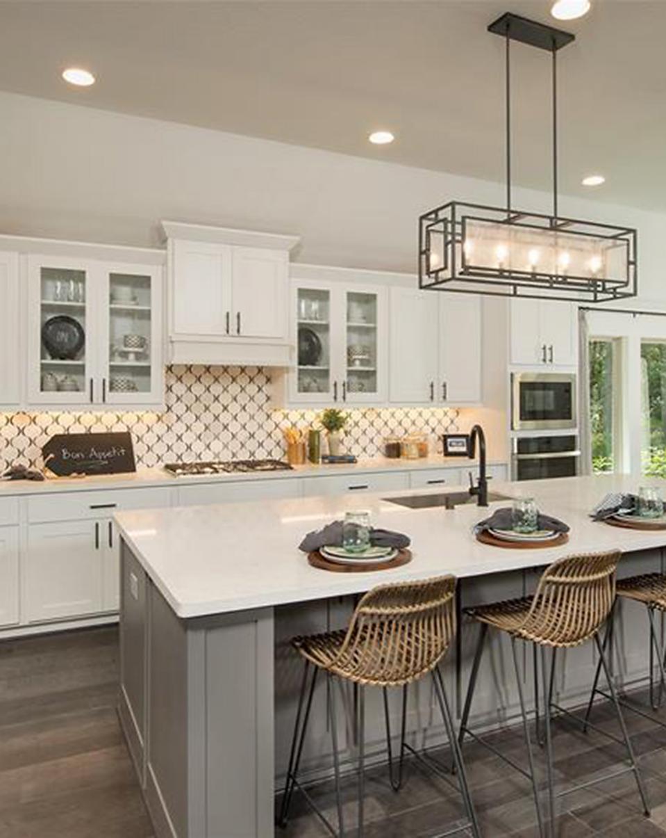 Luxury modern kitchen design inspiration with white counters staged in Woodforest model home.