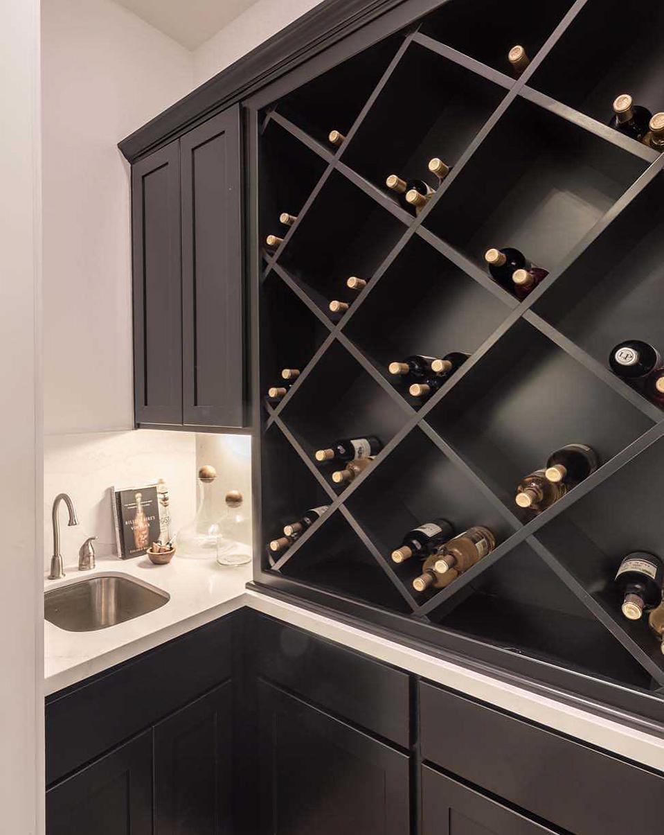 Dark wood wine rack staged in a Woodforest new home builder model.