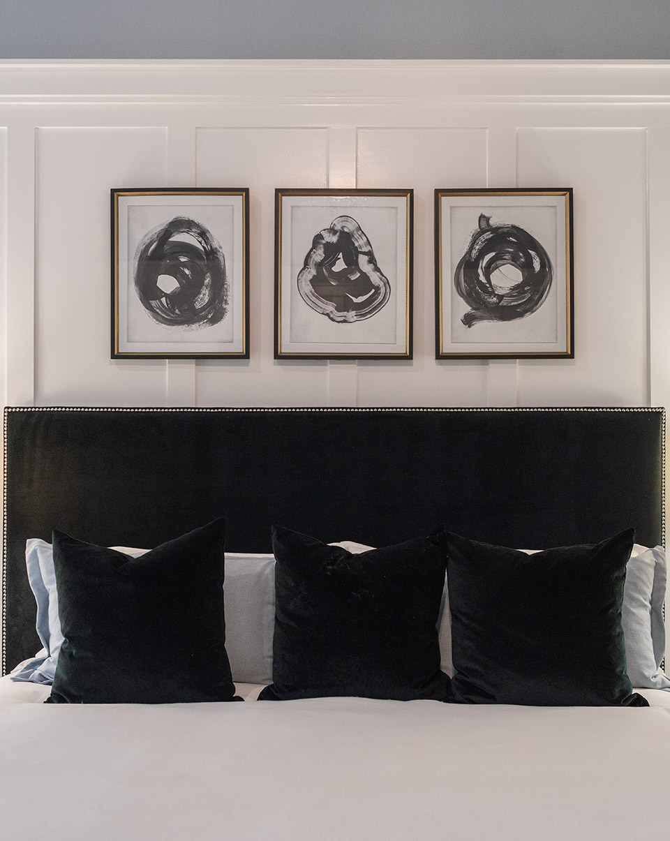 Raised wood pattern statement wall staged in a Woodforest model home bedroom.