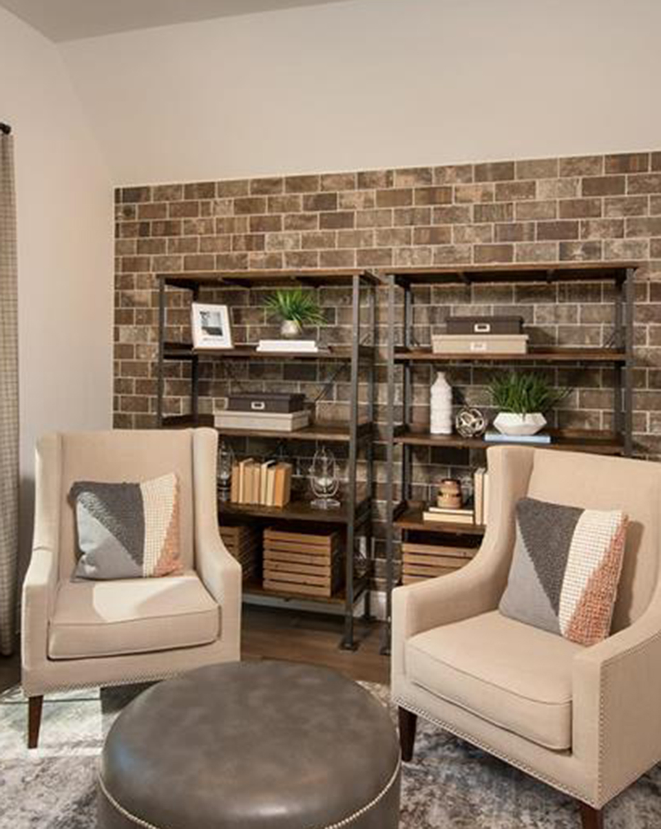 Partially exposed brick accent wall design inspiration staged in Woodforest model home.