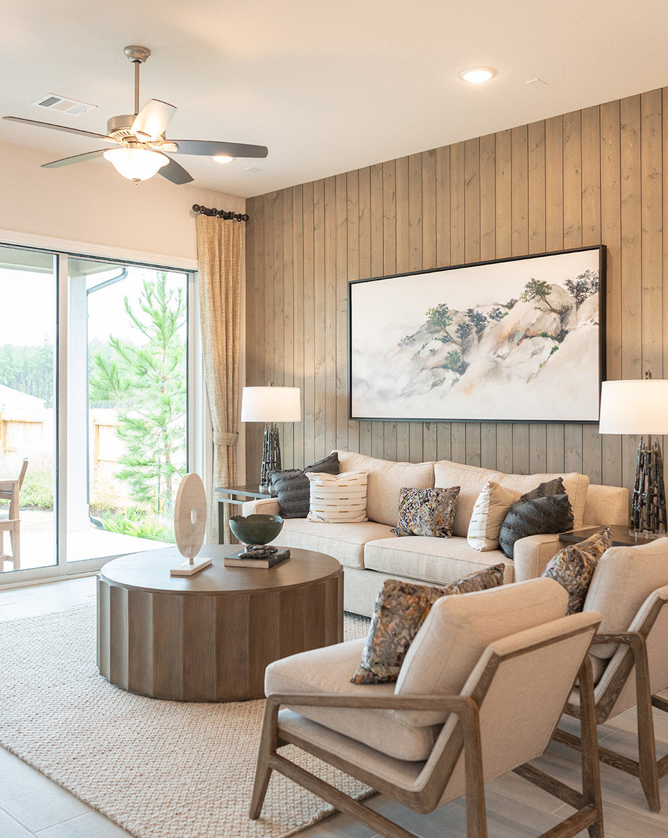 Living room with wood statement wall staged in a Woodforest model home.