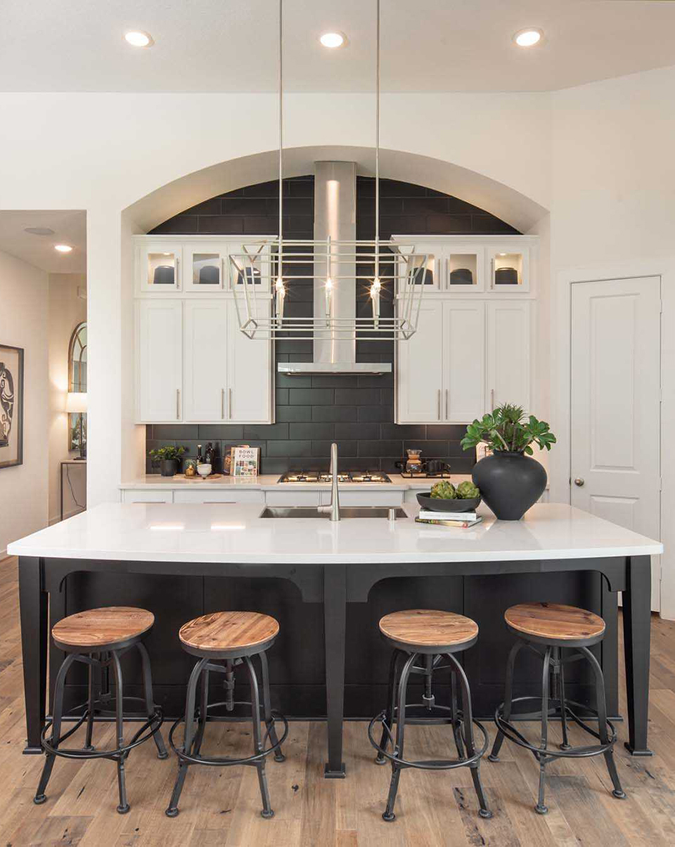 Kitchen design inspiration with stone slabs for backsplash in Woodforest model home.